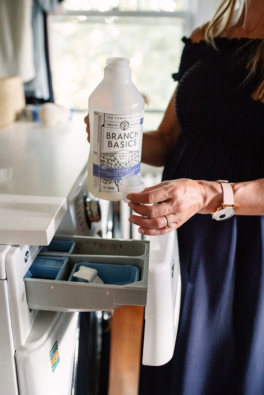 Woman using Branch Basics laundry detergent