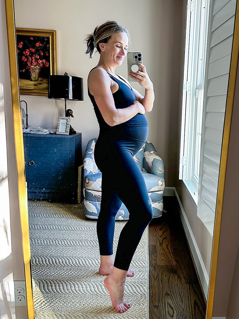 TeriLyn Adams wearing a black Maternity Leggings on Amazon and showing her baby bump