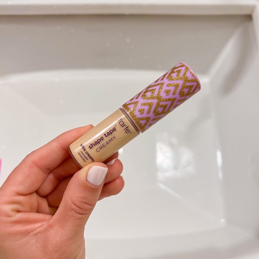 TeriLyn Adams holding the Tarte Ultra Creamy Concealer