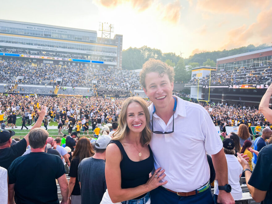 Woman and man wearing football game attire