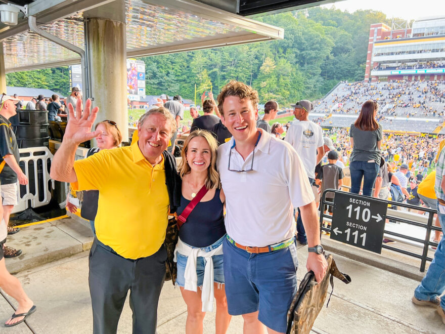 Woman with two guys at a football game