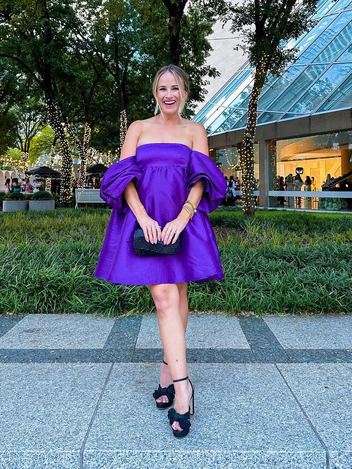 Woman wearing Loeffler Randall Platinum Lame Natalia Heels with formal knee-length dress