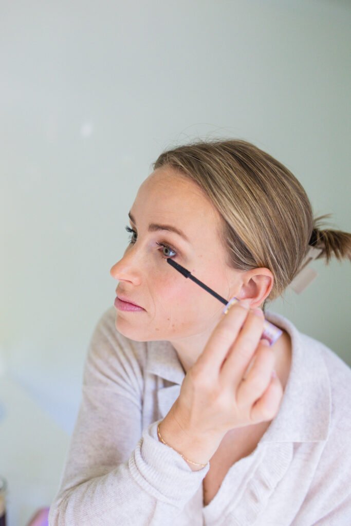 Woman using tubing mascara