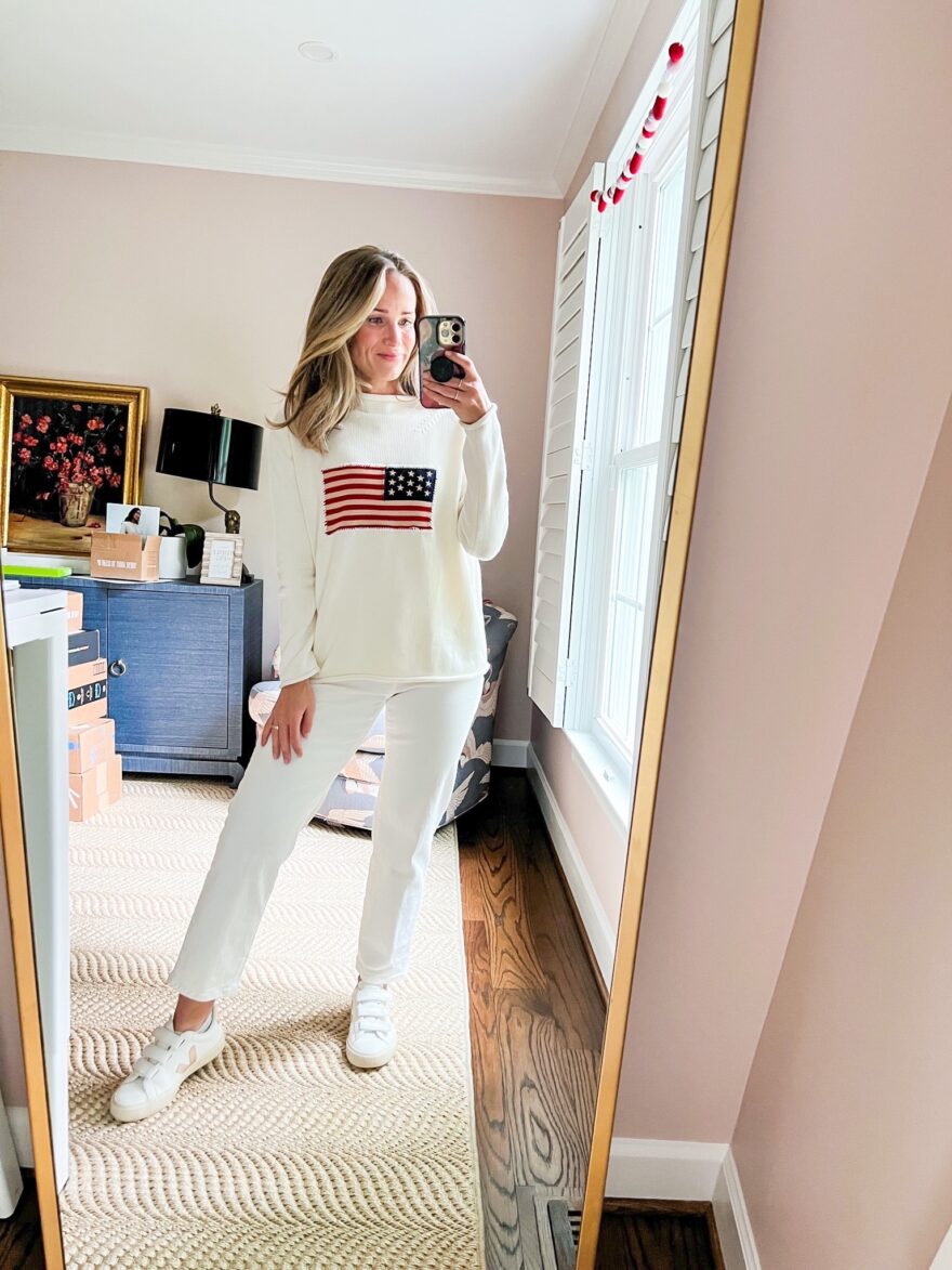 woman wearing Tuckerneck blouses from Ivory Americana Sweater and white pants