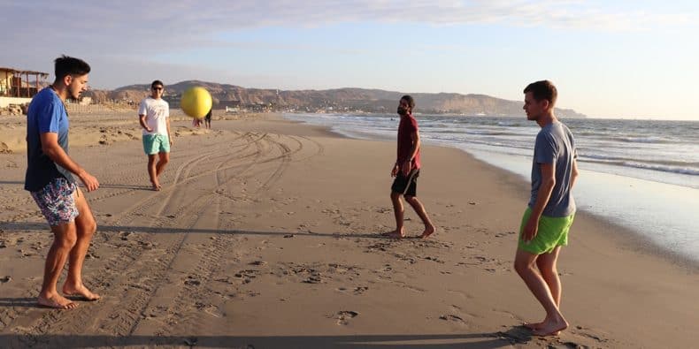 amigos jugando al fútbol en la playa de máncora
