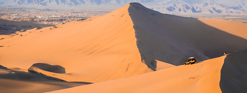 Dune buggy going down a dune in Ica desert, Peru