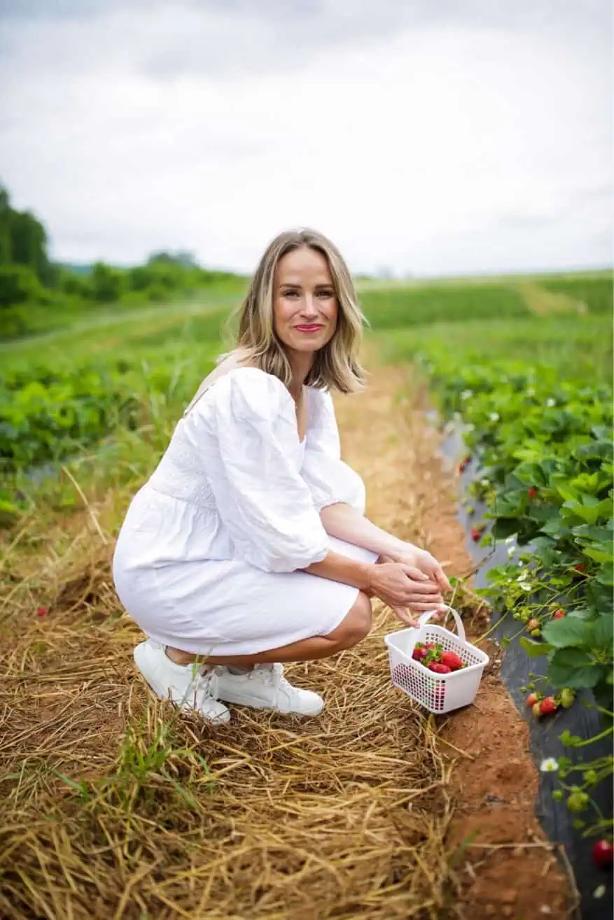 Woman in a field wearing White Annie Smocked Dress