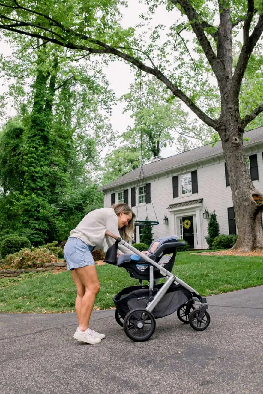 Woman tucking in baby in Uppababy Vista stroller