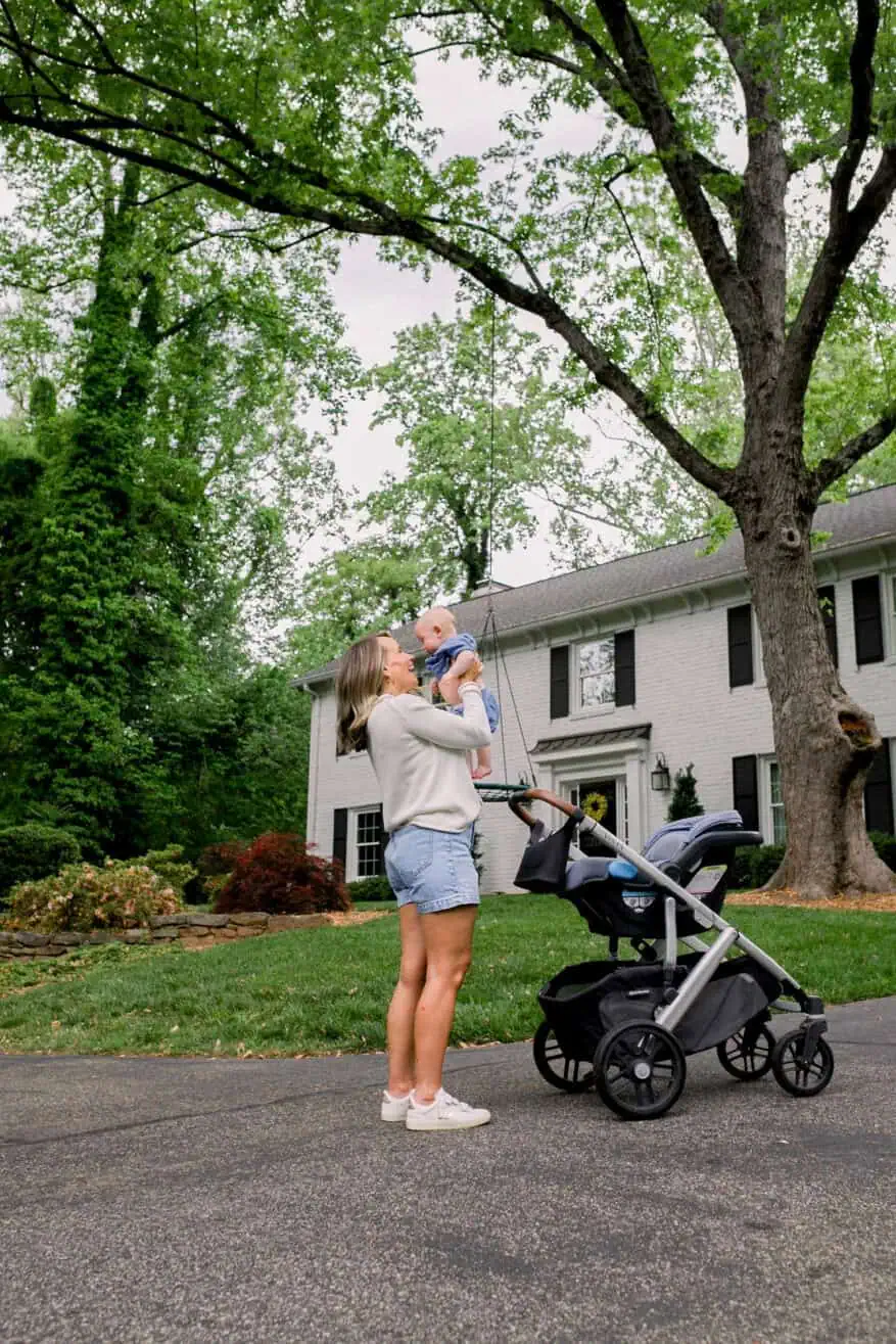 Woman holding baby with Uppababy Vista Stroller