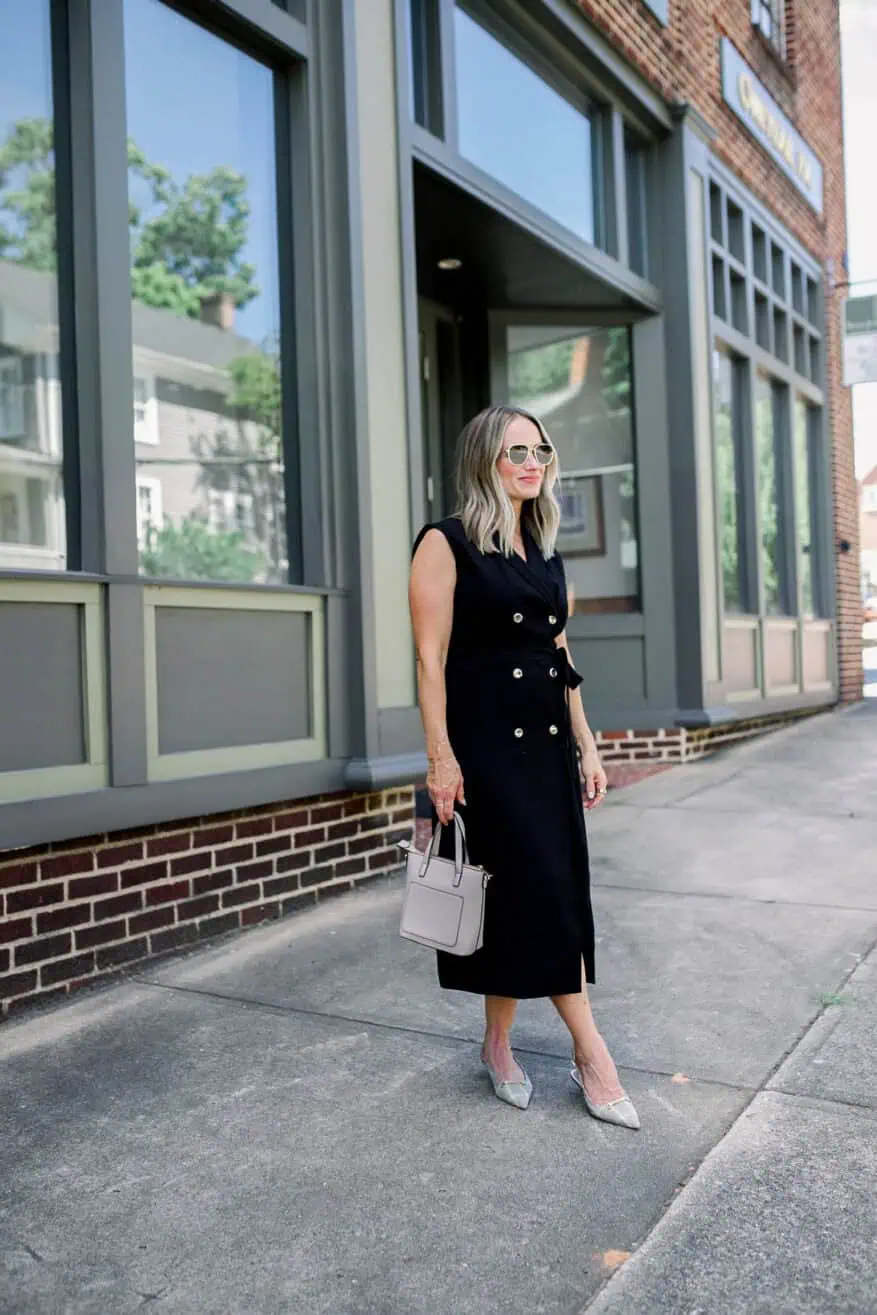 Woman wearing black dress and holding purse