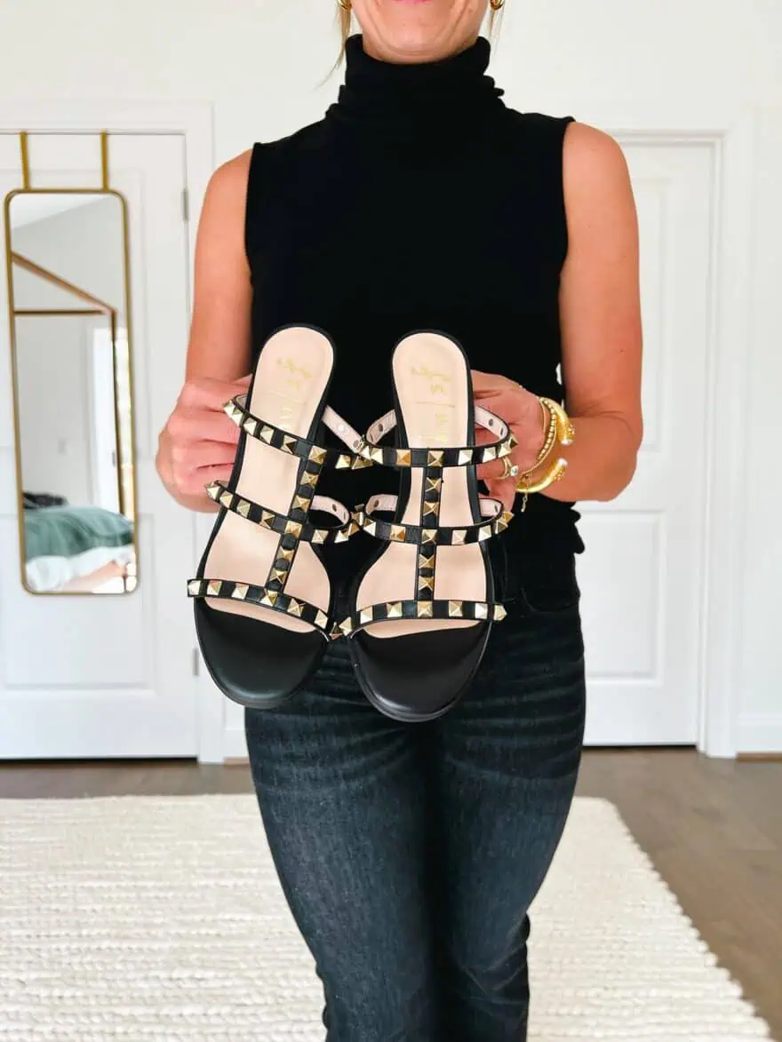 Woman holding French Sole Exclusive Foster Stud Sandals