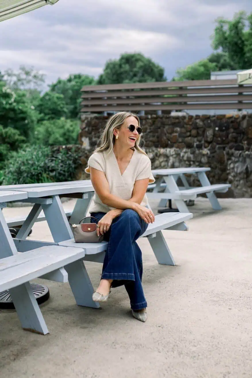 Woman sitting outside wearing denim